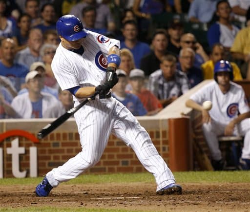 Chicago Cubs' Darwin Barney swings on a three-run home run off Los Angeles Angels starting pitcher Joe Blanton during the sixth inning of a baseball game Tuesday, July 9, 2013, in Chicago. (AP Photo/Charles Rex Arbogast)