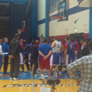 DePaul head coach Oliver Purnell huddles his team before practice.