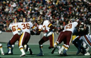 Washington Redskins quarterback Doug Williams (17) prepares to handoff to running back Timmy Smith (36) during the Redskins 21-17 victory over the Chicago Bears in the 1987 NFC Divisional Playoff Game on January 10, 1988 at Soldier Field in Chicago, Illin 1987 NFC Divisional Playoff Game - Washington Redskins vs Chicago Bears - January 10, 1988 (AP Photo/NFL Photos)