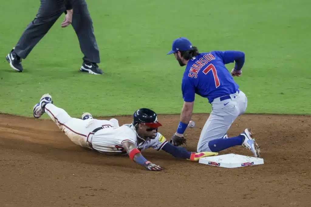 Ronald Acuna Jr. steals his 69th base of the season as Cubs shortstop Dansby Swanson takes the throw.