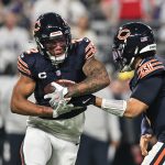 Chicago Bears' DJ Moore got busy at a new position on Monday 2 Chicago Bears Caleb Williams making a hand off to DJ Moore