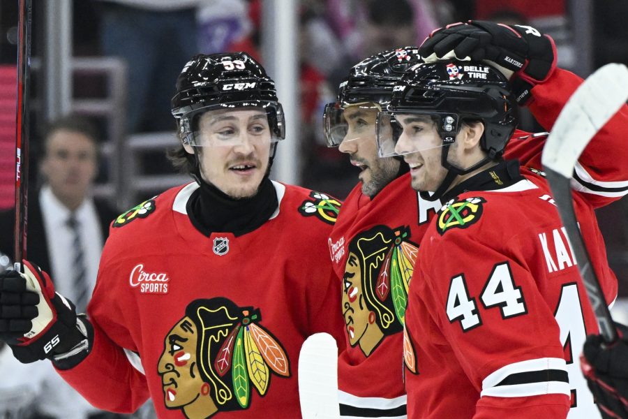 Chicago Blackhawks defenseman Alec Martinez (25), center, celebrates his goal against the Los Angeles Kings with left wing Tyler Bertuzzi (59) and defenseman Wyatt Kaiser (44) during the first period at the United Center.