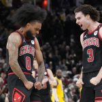 Chicago Bulls guard Coby White (0) celebrates his three point basket against the Los Angeles Lakers with guard Josh Giddey (3) during the second half at United Center.