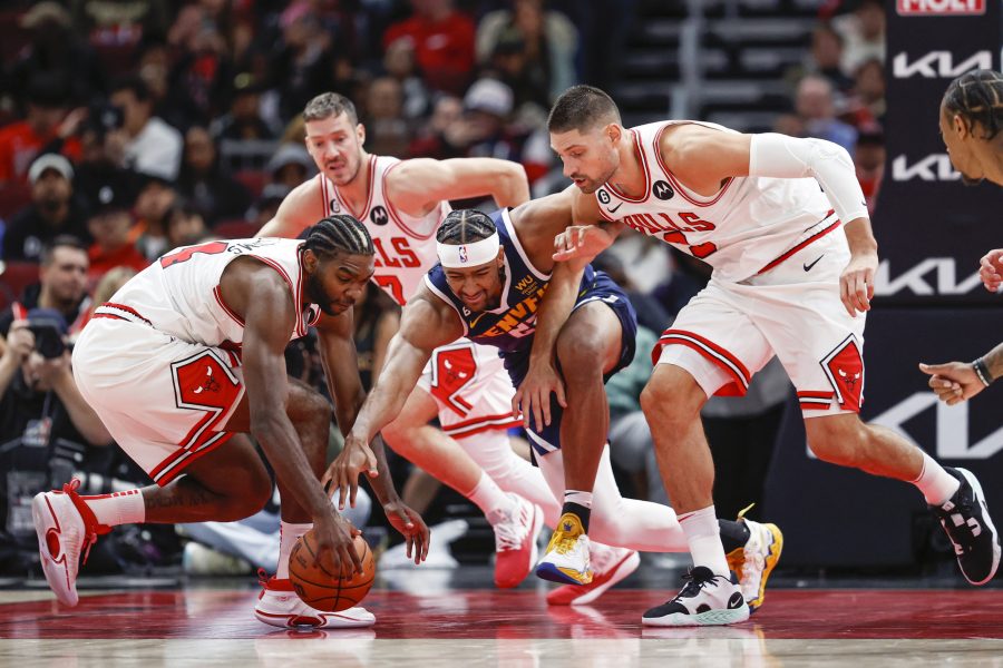 NBA: Preseason Denver Nuggets at Chicago Bulls Chicago Bulls forward Patrick Williams (44) and center Nikola Vucevic (9) battle for the ball with Denver Nuggets forward Zeke Nnaji (22) during the first half at United Center.