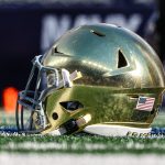 A Notre Dame Fighting Irish helmets rests on the field before the game between the Fighting Irish and the Navy Midshipmen at MetLife Stadium.