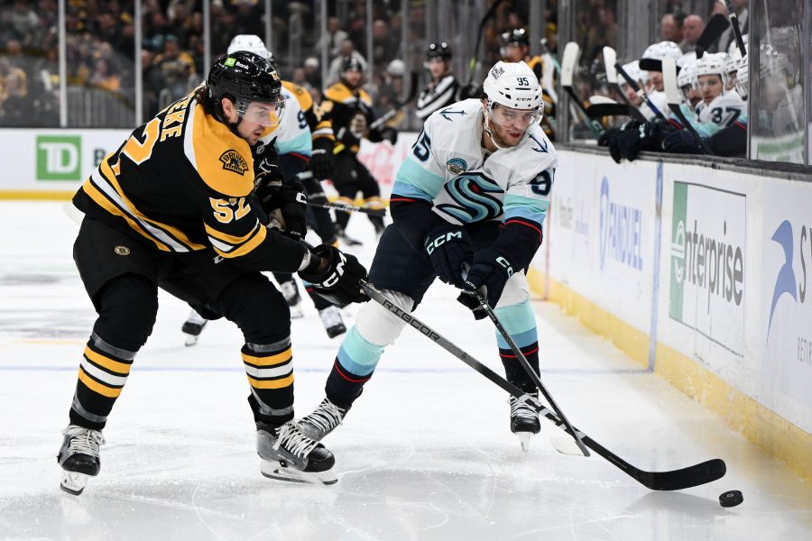 NHL: Seattle Kraken at Boston Bruins , USA; Seattle Kraken left wing Andre Burakovsky (95) battle for the puck against Boston Bruins defenseman Andrew Peeke (52) during the second period at the TD Garden.