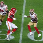 San Francisco 49ers running back Raheem Mostert (31) tries to avoid Kansas City Chiefs defensive end Tanoh Kpassagnon (92) in Super Bowl LIV at Hard Rock Stadium.