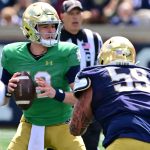 Notre Dame Fighting Irish quarterback CJ Carr (12) is pressured by defensive lineman Sean Sevillano Jr. (59) in the second half of the Blue-Gold Game at Notre Dame Stadium.