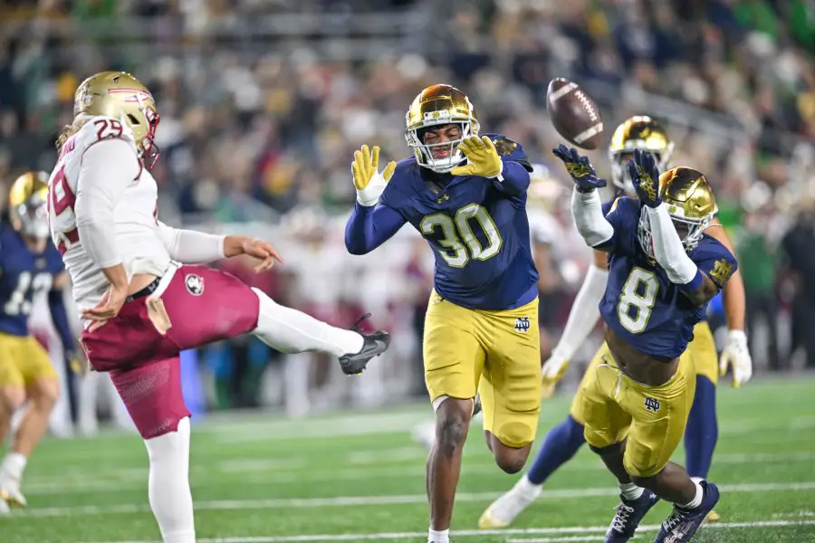 Notre Dame Fighting Irish defensive lineman Bryce Young (30) and safety Adon Shuler (8) rush a punt by Florida State Seminoles punter Alex Mastromanno (29) in the second quarter at Notre Dame Stadium. 