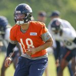Chicago Bears quarterback Caleb Williams (18) warms up during training camp at Halas Hall.