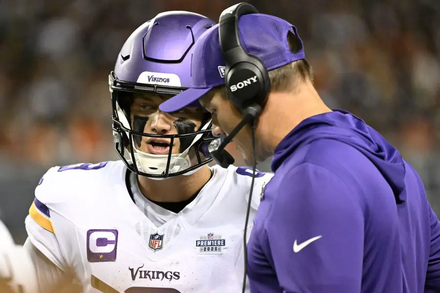 Minnesota Vikings head coach Kevin O'Connell talks with quarterback J.J. McCarthy (9) during the first half at Soldier Field. 