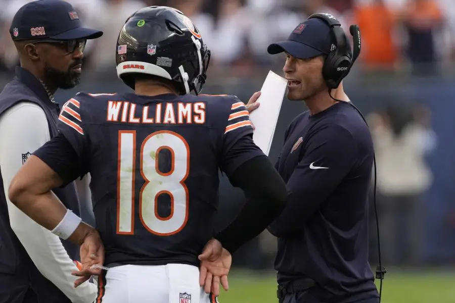 Chicago Bears head coach Ben Johnson talks with quarterback Caleb Williams (18) against the Dallas Cowboys during the second half at Soldier Field.